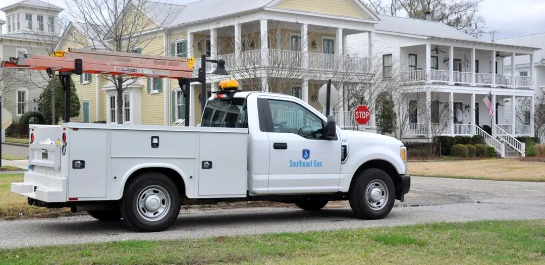 A Southeast Gas worker truck sitting in front of a house.